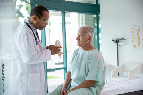 Doctor examining senior patient in hospital photo