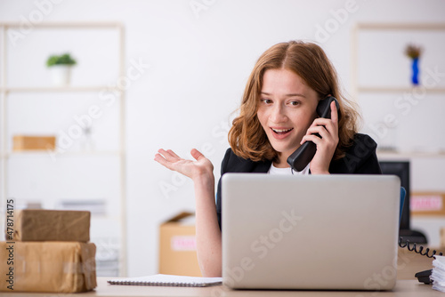 Young woman working in box delivery service