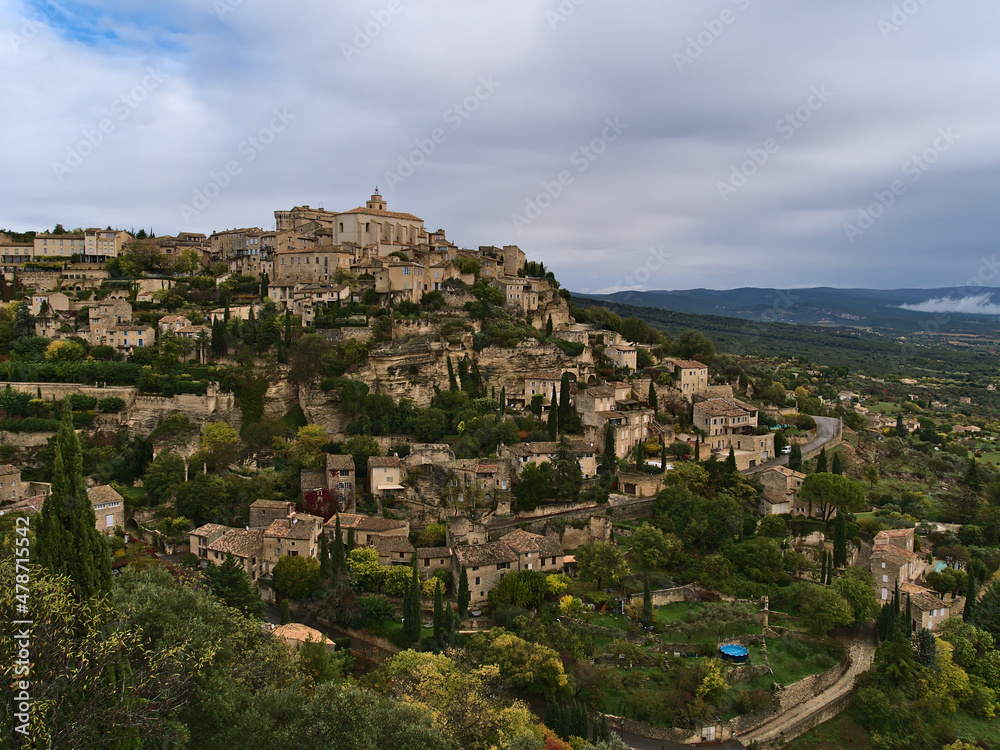 Beautiful view of small village Gordes located on a rocky hill above Luberon valley in Provence region, France with historic stone buildings.