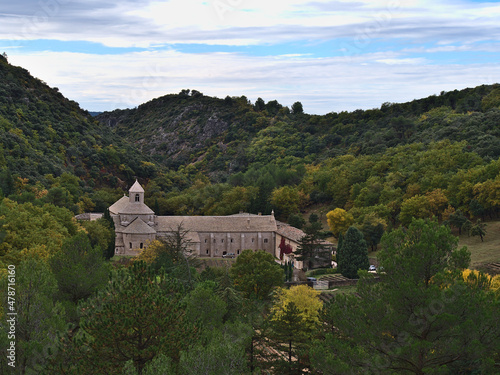 View of Cistercian monastery Abbaye Notre-Dame de Senanque located in a remote valley near Gordes, France in Provence region on cloudy day in autumn. © Timon