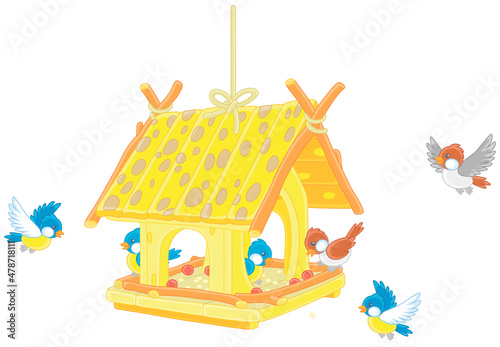 Merry small sparrows and titmice flying around a fancy birdfeeder hanging on a branch, vector cartoon illustration isolated on a white background