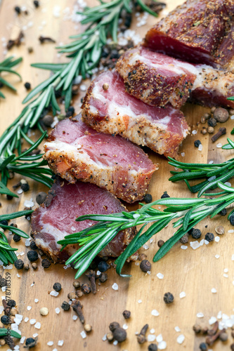 Fototapeta Naklejka Na Ścianę i Meble -  dried and spiced meat sliced on a wooden board