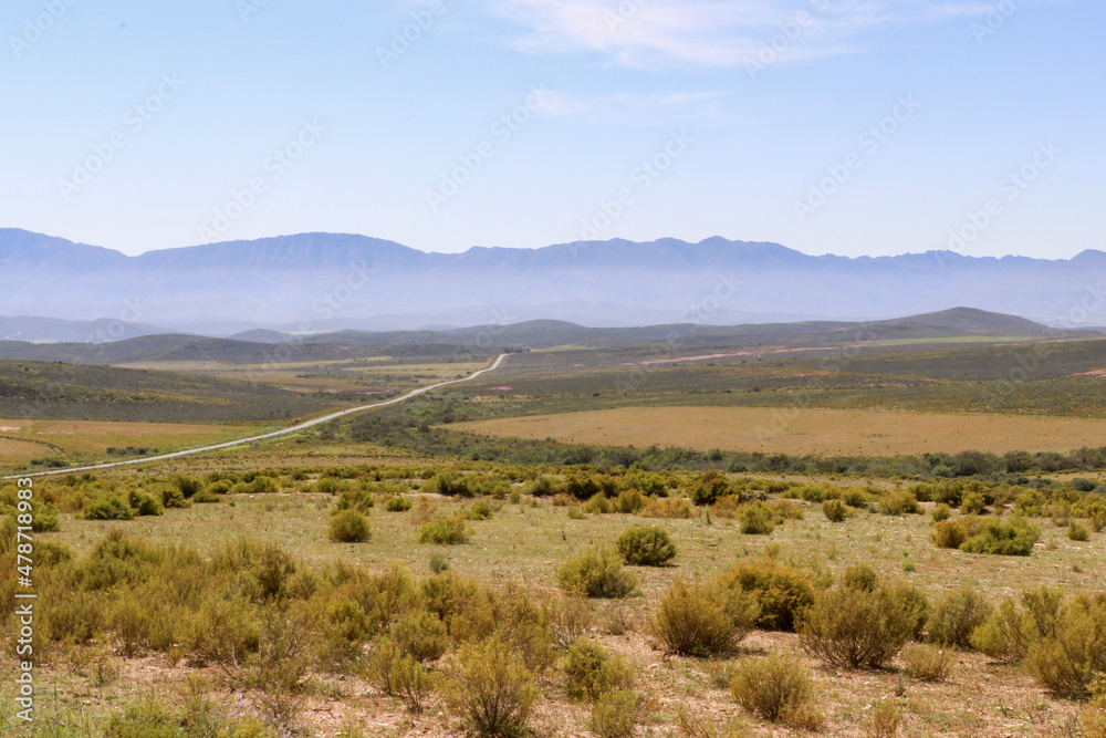 travelling through landscape with mountains and blue sky
