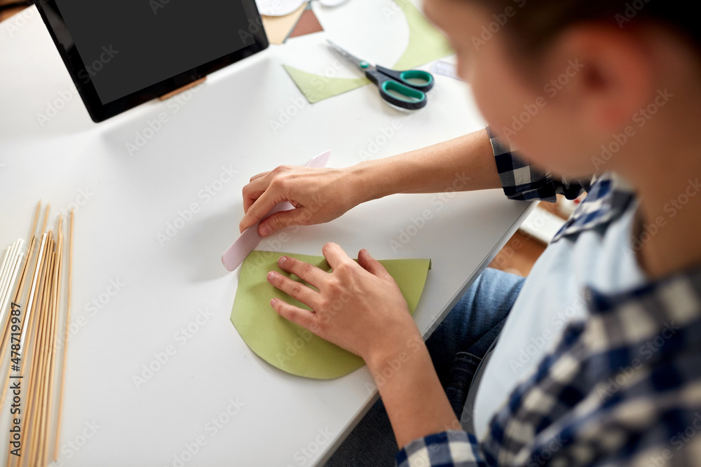 diy, art and hobby concept - close up of woman with tablet pc computer making paper craft at home diy, art and hobby concept - close up of woman with tablet pc computer making paper craft at home