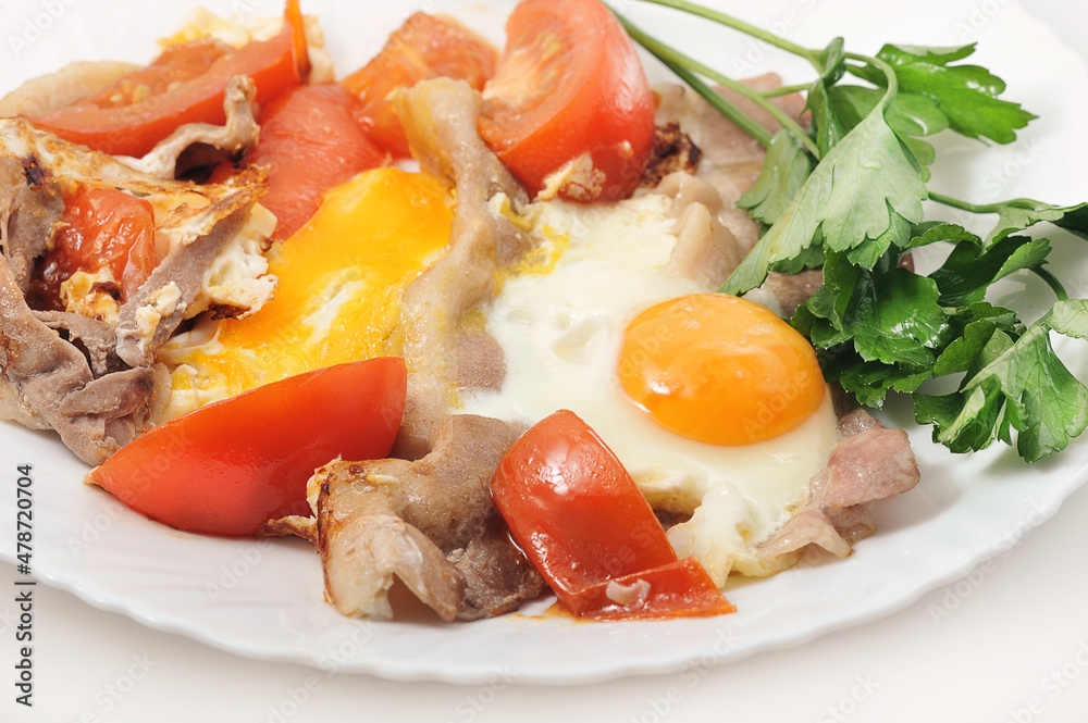 scrambled eggs with bacon and tomatoes in a plate with parsley scrambled eggs with bacon and tomatoes in a plate with parsley