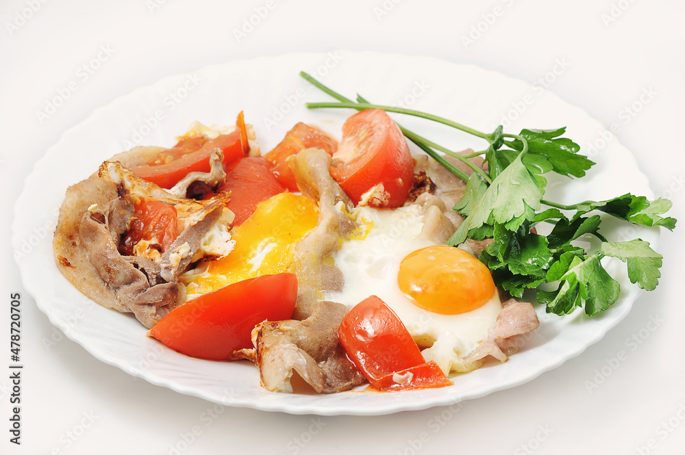 scrambled eggs with bacon and tomatoes in a plate with parsley scrambled eggs with bacon and tomatoes in a plate with parsley