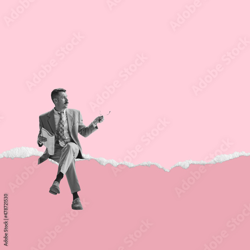 Contemporary art collage of man sitting on edge of a torn sheet of paper isolated over pink background