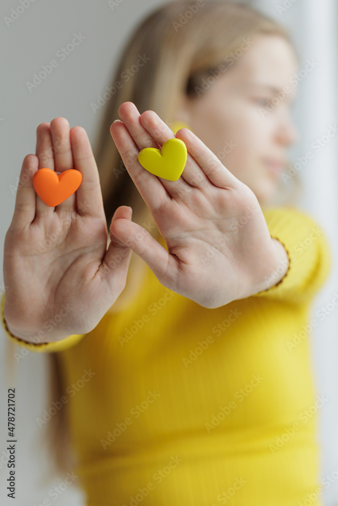 Teenage girl chooses jewelry earrings. Heart shaped earrings. St. Valentine's Day. High quality photo Teenage girl chooses jewelry earrings. Heart shaped earrings. St. Valentine's Day. High quality photo