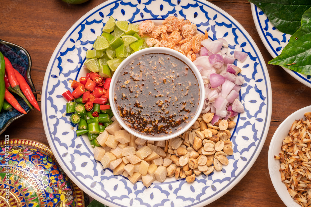 Miang Kham Or wild betel leaves Wrap Ingredients dried shrimps, peanuts, lime, chilli, roasted peanuts with sweet dipping sauce, Asian appetizer food. Miang Kham Or wild betel leaves Wrap Ingredients dried shrimps, peanuts, lime, chilli, roasted peanuts with sweet dipping sauce, Asian appetizer food.