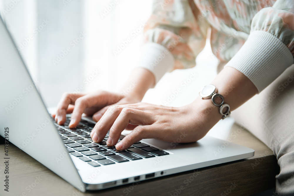 Happy Asian young woman making a video conference on laptop computer while living in the living room, cheerful Asian woman making a gesture or hands sign in video call. Happy Asian young woman making a video conference on laptop computer while living in the living room, cheerful Asian woman making a gesture or hands sign in video call.
