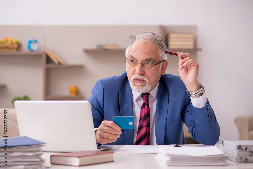 Old male teacher employee working from home during pandemic