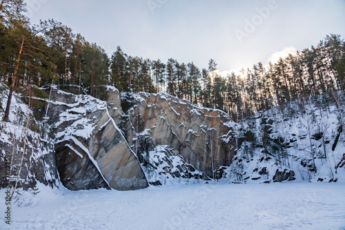 Sheer cliffs and rocks around the Talc quarry in winter in Russia in the town of Sysert, near Yekaterinburg. photo