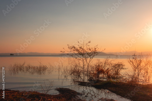 On the shore of the lake in the late afternoon