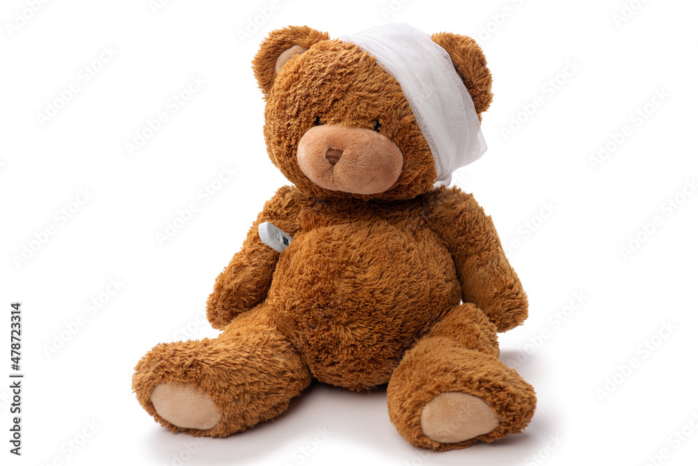 Obraz premium medicine, healthcare and childhood concept - teddy bear toy with bandaged head and thermometer on white background