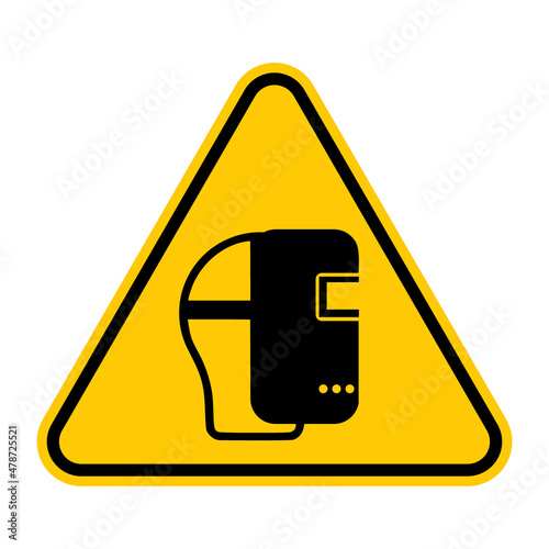 Wear welding mask sign. Vector illustration of yellow triangle warning sign with human head wearing welding mask icon inside. Protective face shield symbol. Caution. Personal protection safety concept