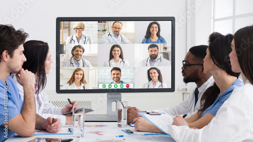 Group Of Multiracial Doctors Communicating Online Having Virtual Meeting Indoor