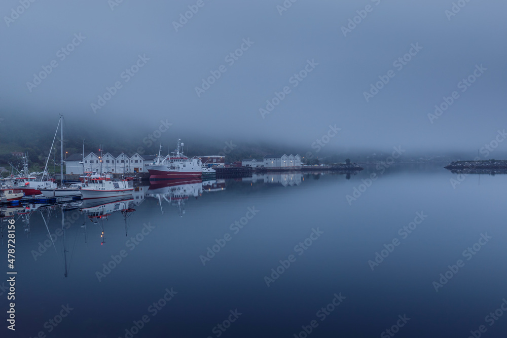 Morning view of the port. Misty background. Ships are in the harbor. Mystical landscape. Early blue morning. Norway. Senja. Scandinavia.
