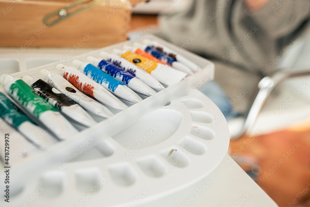 Paint tubes arranged in box over palette Paint tubes arranged in box over palette