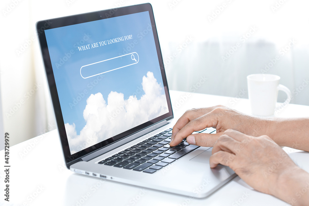 Man hands working with laptop to searching internet data information with blank search bar. Man hands working with laptop to searching internet data information with blank search bar.