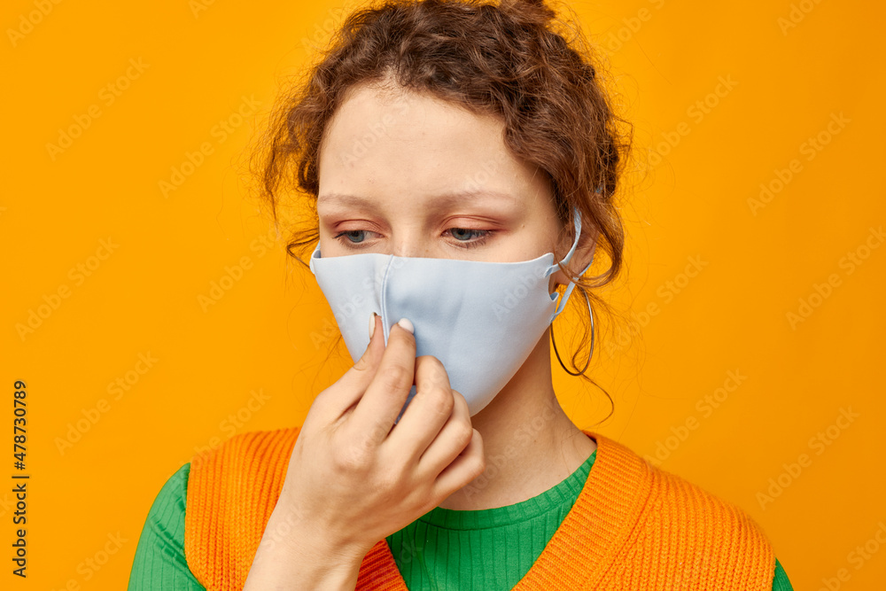 cheerful woman in a yellow t-shirt medical mask protection pink background unaltered cheerful woman in a yellow t-shirt medical mask protection pink background unaltered