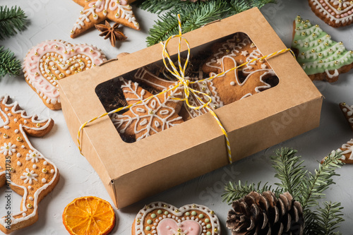 Christmas homemade gingerbread cookies in a gift box on a grey table
