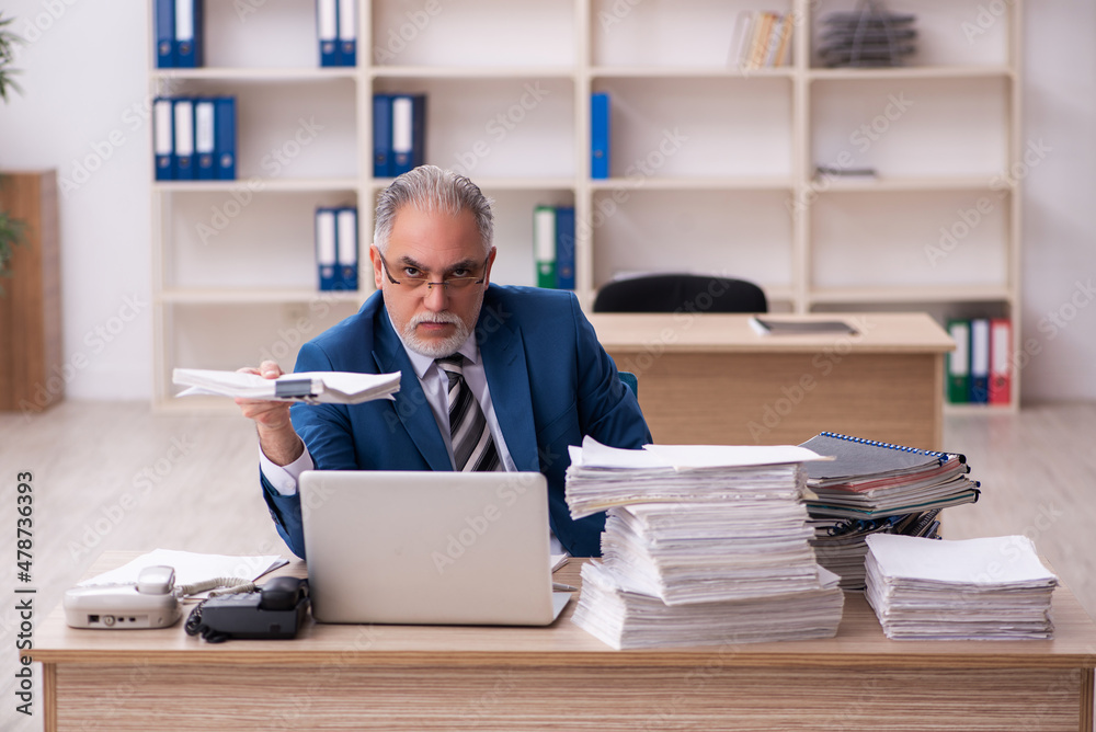 Old male employee and too much work in the office Old male employee and too much work in the office