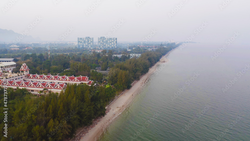 Aerial view of Cha am beach, Thailand island in summer with seawater and tropical green forest trees with Andaman sea in travel trip. Nature landscape.