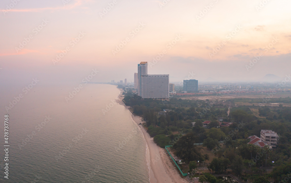 Aerial view of Cha am beach, Thailand island in summer with seawater and tropical green forest trees with Andaman sea in travel trip. Nature landscape.