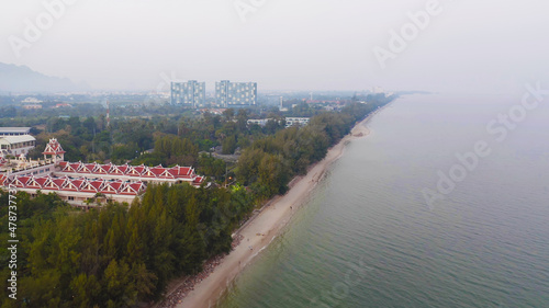 Aerial view of Cha am beach  Thailand island in summer with seawater and tropical green forest trees with Andaman sea in travel trip. Nature landscape.
