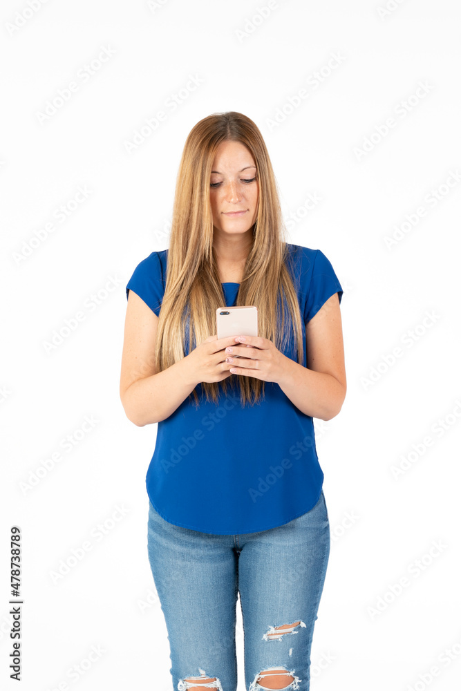 Young woman on a white background looking at the smartphone. Young woman on a white background looking at the smartphone.
