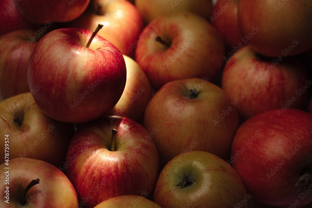 Apples fruit. Several fresh apples in shade under sunbeam Apples fruit. Several fresh apples in shade under sunbeam