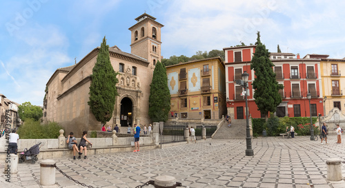 View at the St. Ana square with San Gil and Santa Ana Church, heritage colored buildings and Carrera del Darro to the street sad walk in Granada, Spain photo