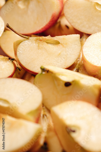 Sliced apples fruit. Vertical macro view of many slices of cut apples