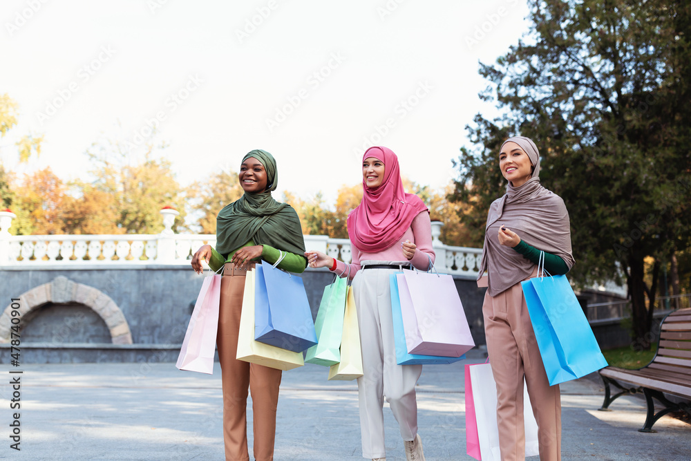 Group Of Muslim Women Doing Shopping Walking Carrying Bags Outdoors Group Of Muslim Women Doing Shopping Walking Carrying Bags Outdoors