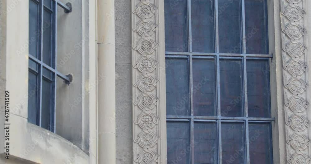 Antique Windows Of The Armenian Cathedral Of Lviv In The Old Town In Ukraine. medium shot, panning right Antique Windows Of The Armenian Cathedral Of Lviv In The Old Town In Ukraine. medium shot, panning right