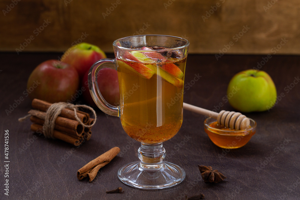 homemade apple cider with fresh apples and honey. Hot fruit tea with spices:cinnamon, cardamon, anise, clove on the wooden table. Christmas drinks with sackcloth. cope space.mulled wine homemade apple cider with fresh apples and honey. Hot fruit tea with spices:cinnamon, cardamon, anise, clove on the wooden table. Christmas drinks with sackcloth. cope space.mulled wine
