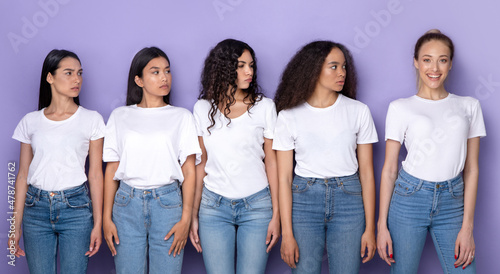 Valokuva Envious Multiracial Ladies Looking At Happy Blonde Woman, Purple Background