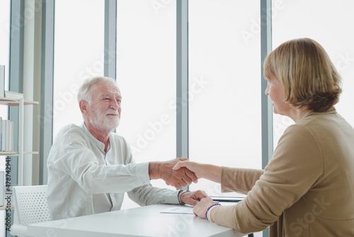 The senior elderly people sitting and handshake for contract agreement.