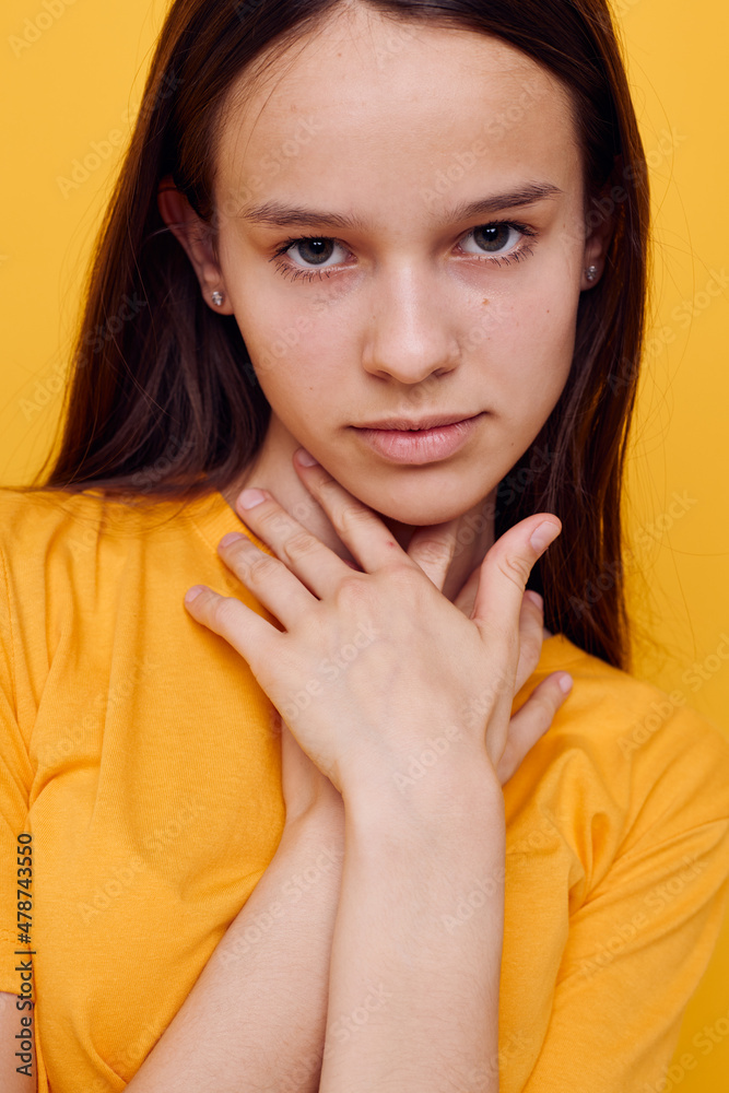 optimistic young woman fashion in yellow t-shirt denim shorts isolated background optimistic young woman fashion in yellow t-shirt denim shorts isolated background