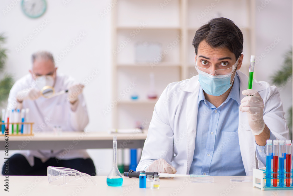 Two male chemists working at the lab during pandemic Two male chemists working at the lab during pandemic