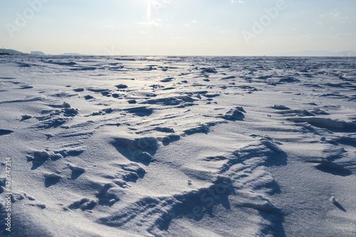 Winter landscape - frozen sea surface with snow.