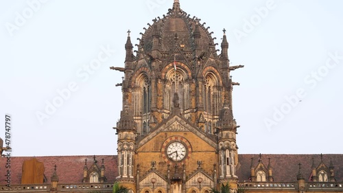 4K Close up Real time still video of the clock tower of Chhatrapati Shivaji Terminus (CST) Railway station building during sunset. It is an UNESCO Heritage site.  Mumbai, Maharashtra, India. 3953. photo