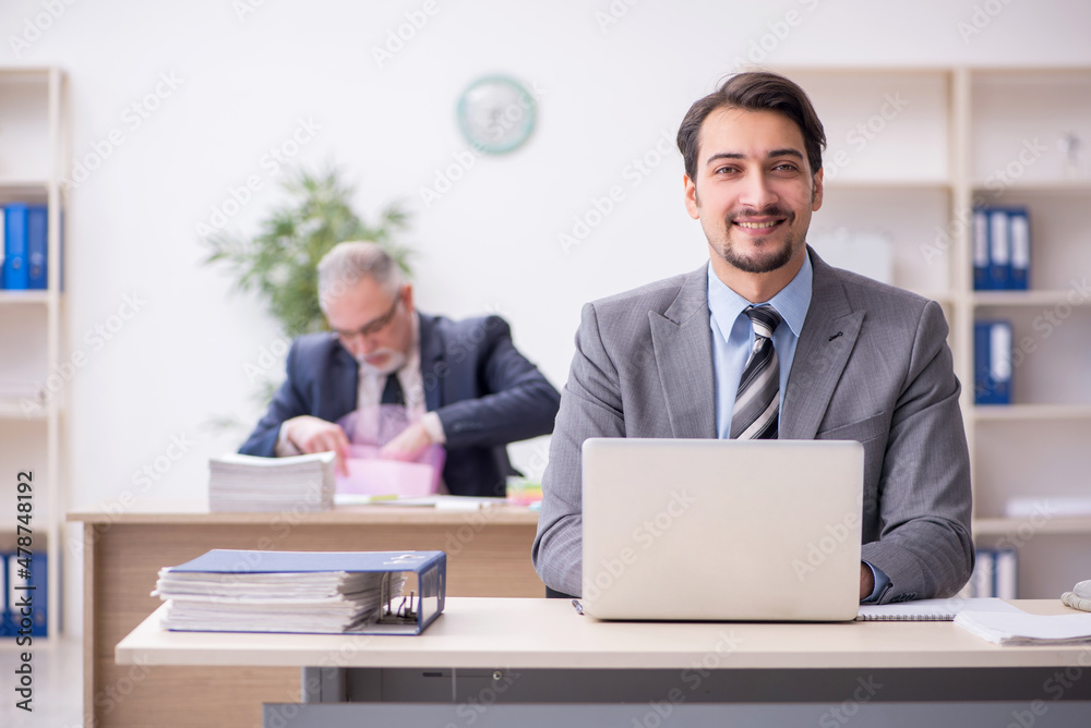 Two male employees working in the office Two male employees working in the office