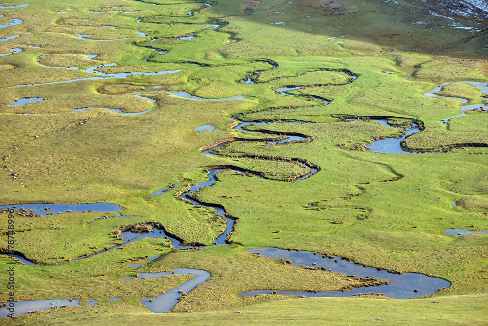 Meandering stream with mountains and clouds at The Persembe Plateau at Ordu, Turkey