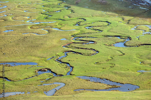 Meandering stream with mountains and clouds at The Persembe Plateau at Ordu, Turkey