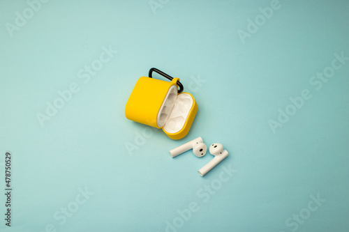 Bright musical headphones lie on a blue background