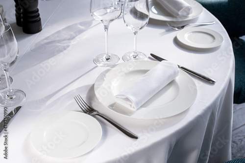 table serving with tablewear glasses and plates in restaurant. selected focus photo