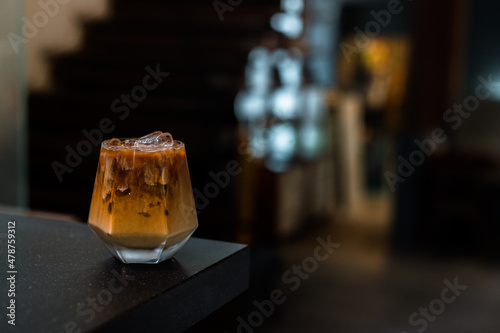 iced coffee with milk  served on the black table at a cafe​ © pariwatpannium