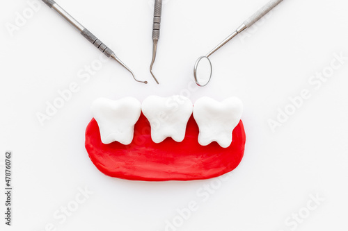 Oral health and care concept with teeth models with dentist tools