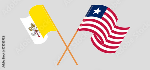 Crossed and waving flags of Vatican and Liberia
